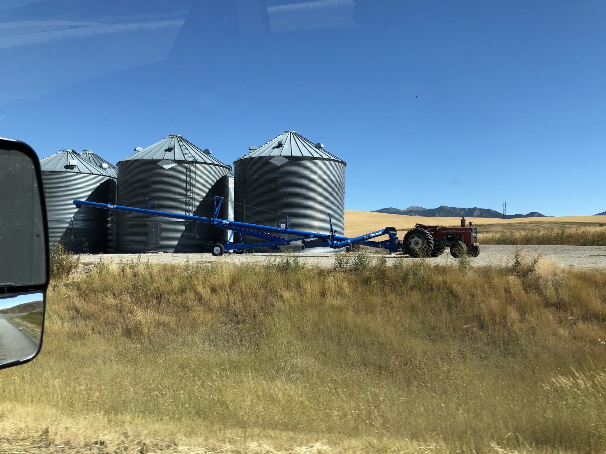 alt="grain silos & tractor"