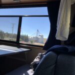 alt="looking out of van window at grain silos"