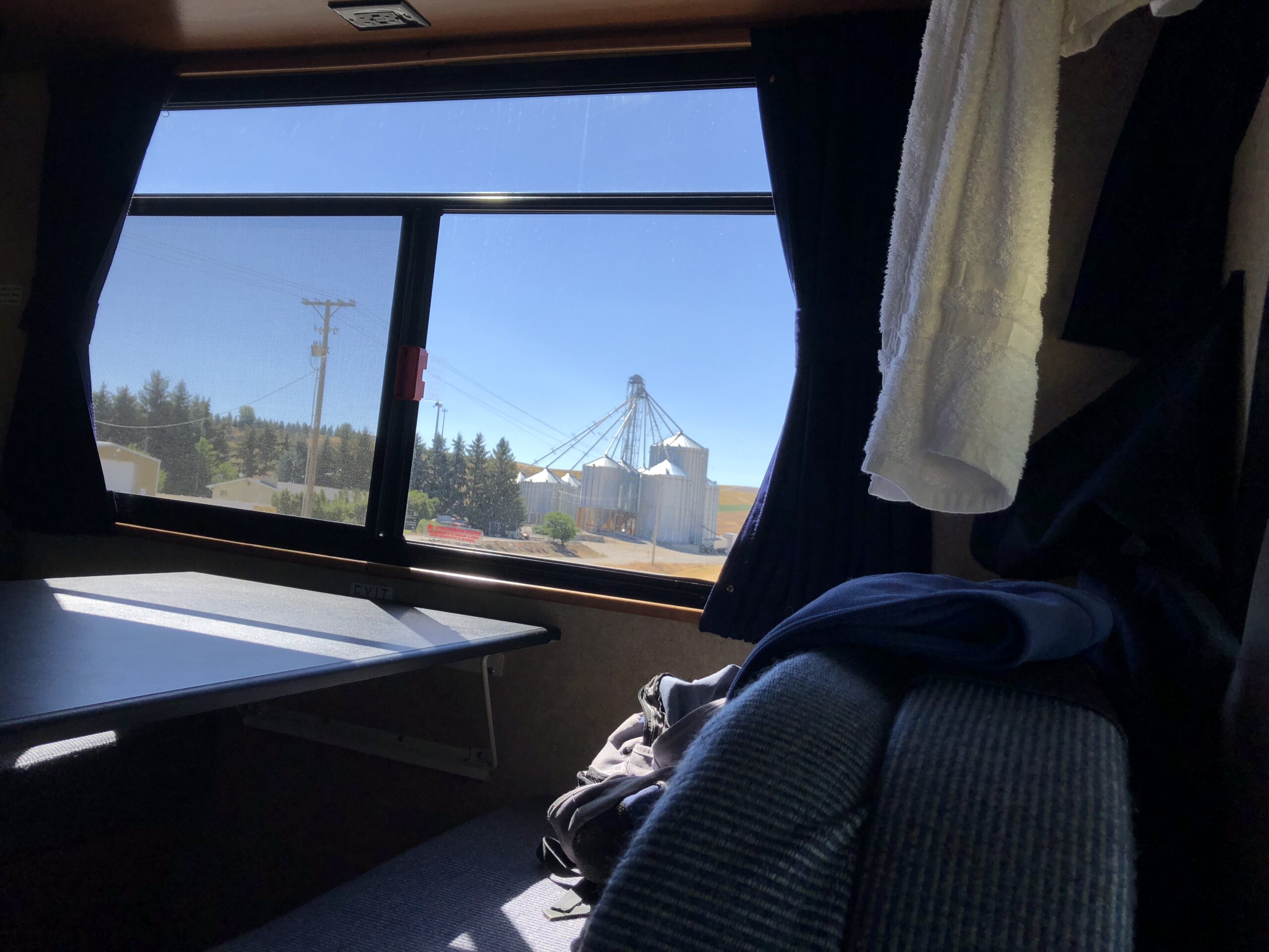 alt="looking out of van window at grain silos"