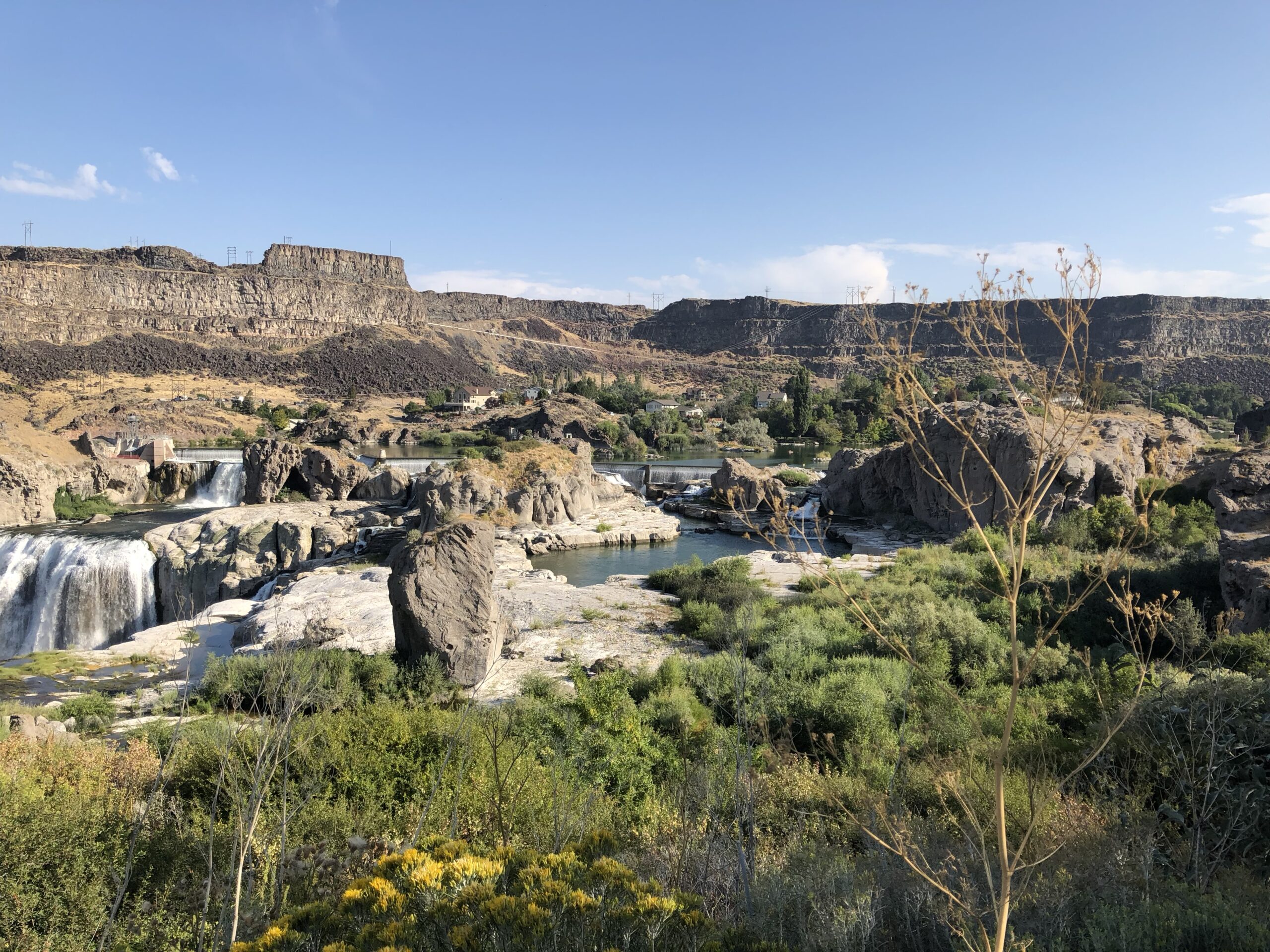 alt="looking across the scrub land from the footpath towards the waterfalls"
