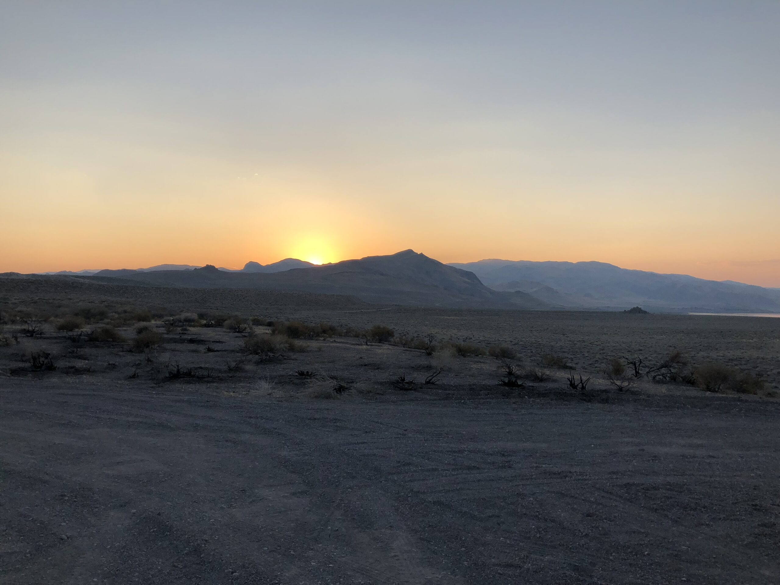alt="sunsetting behind mountain"