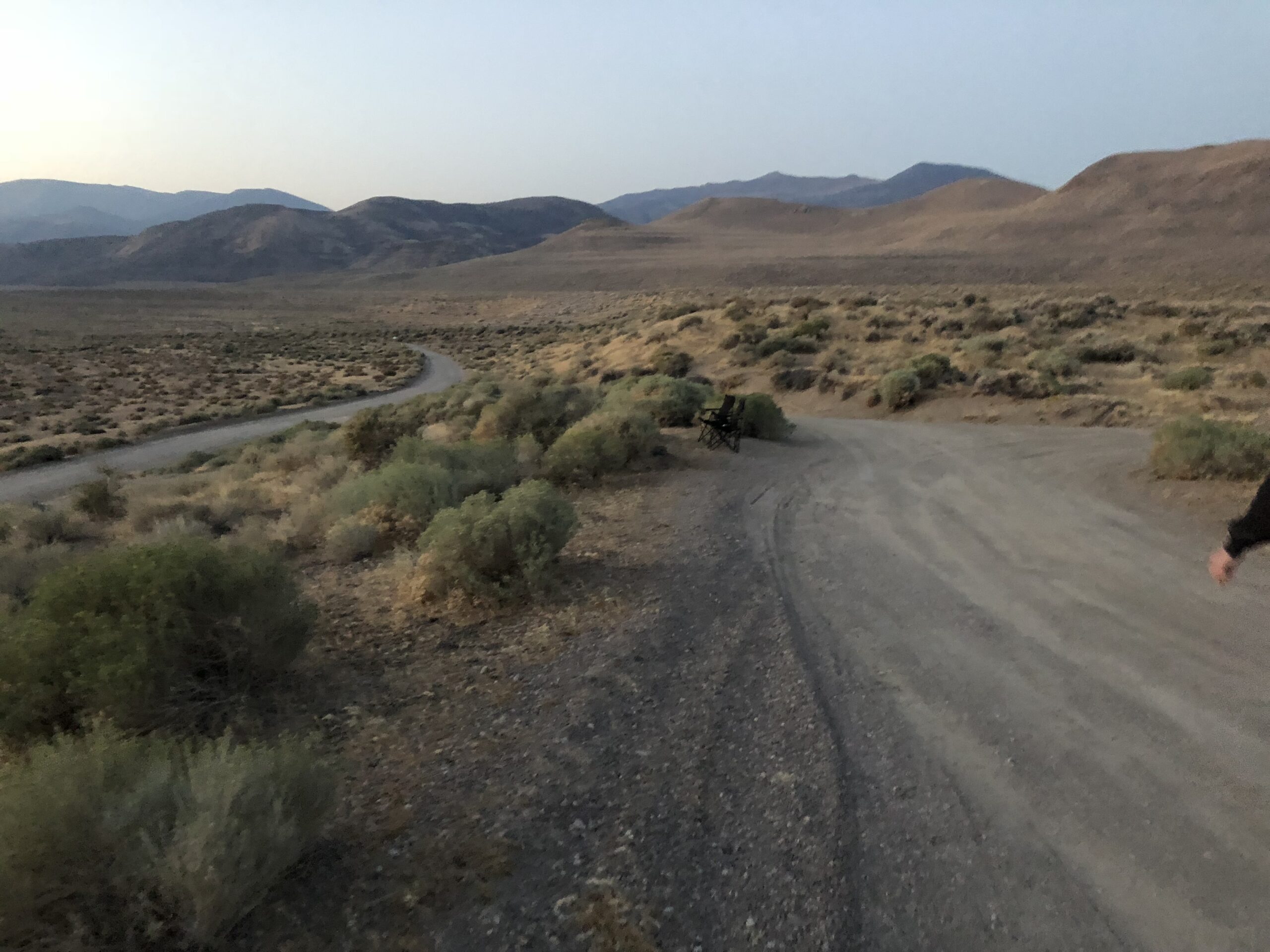 alt="rough track with mountains on background"