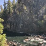 alt=rugged rock outcrop with river below"