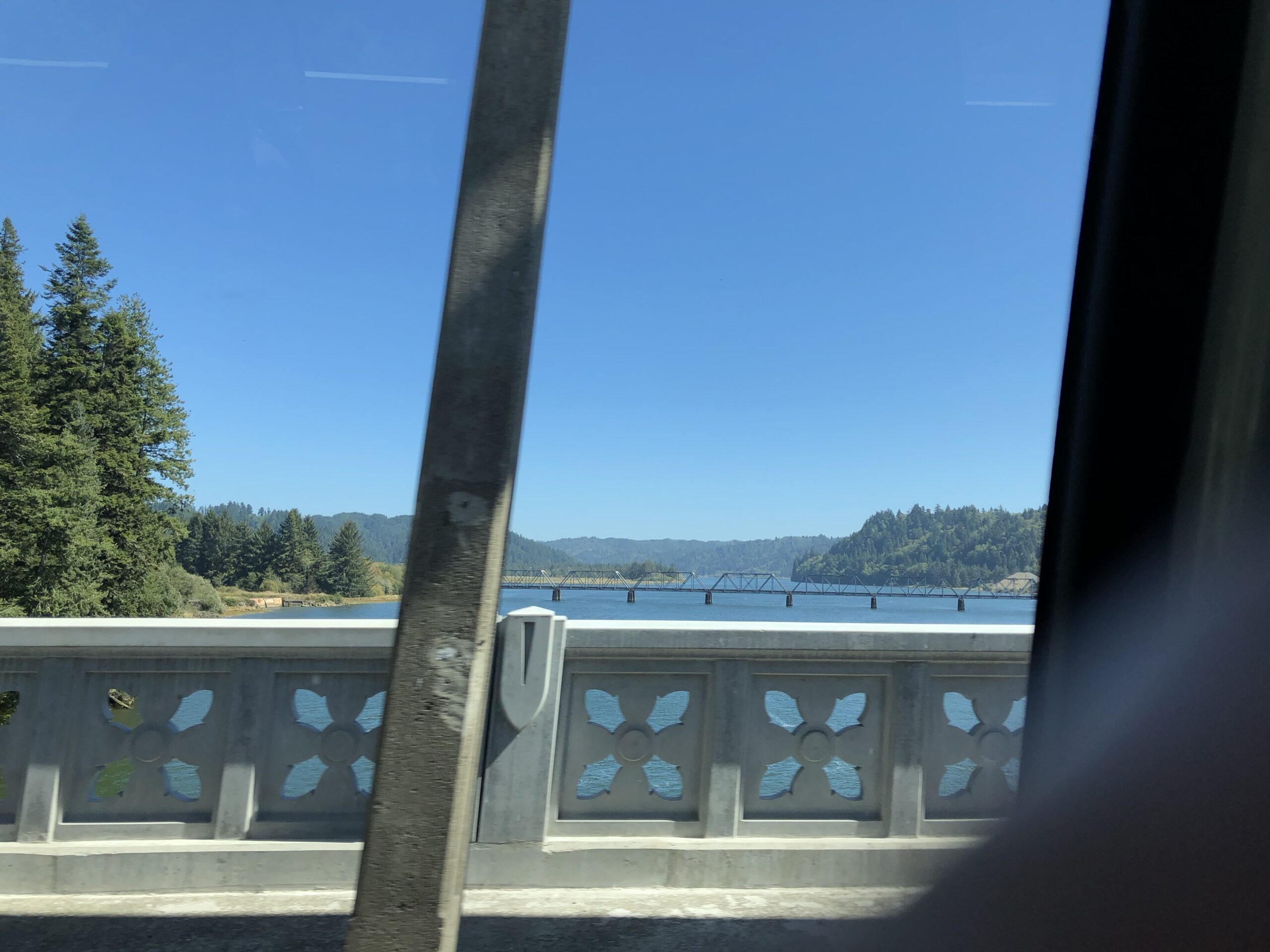 alt="from one bridge looking at another in distance across a river"