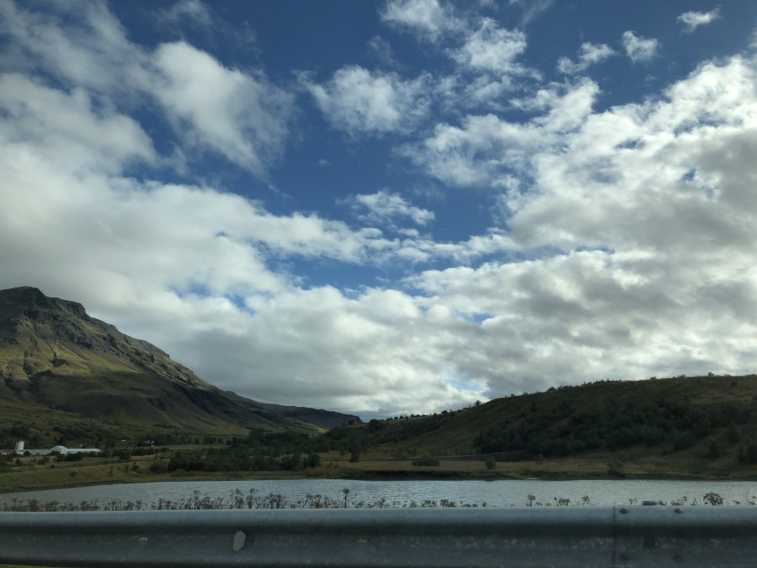 alt=lake with mountain in background & cloudy sky"