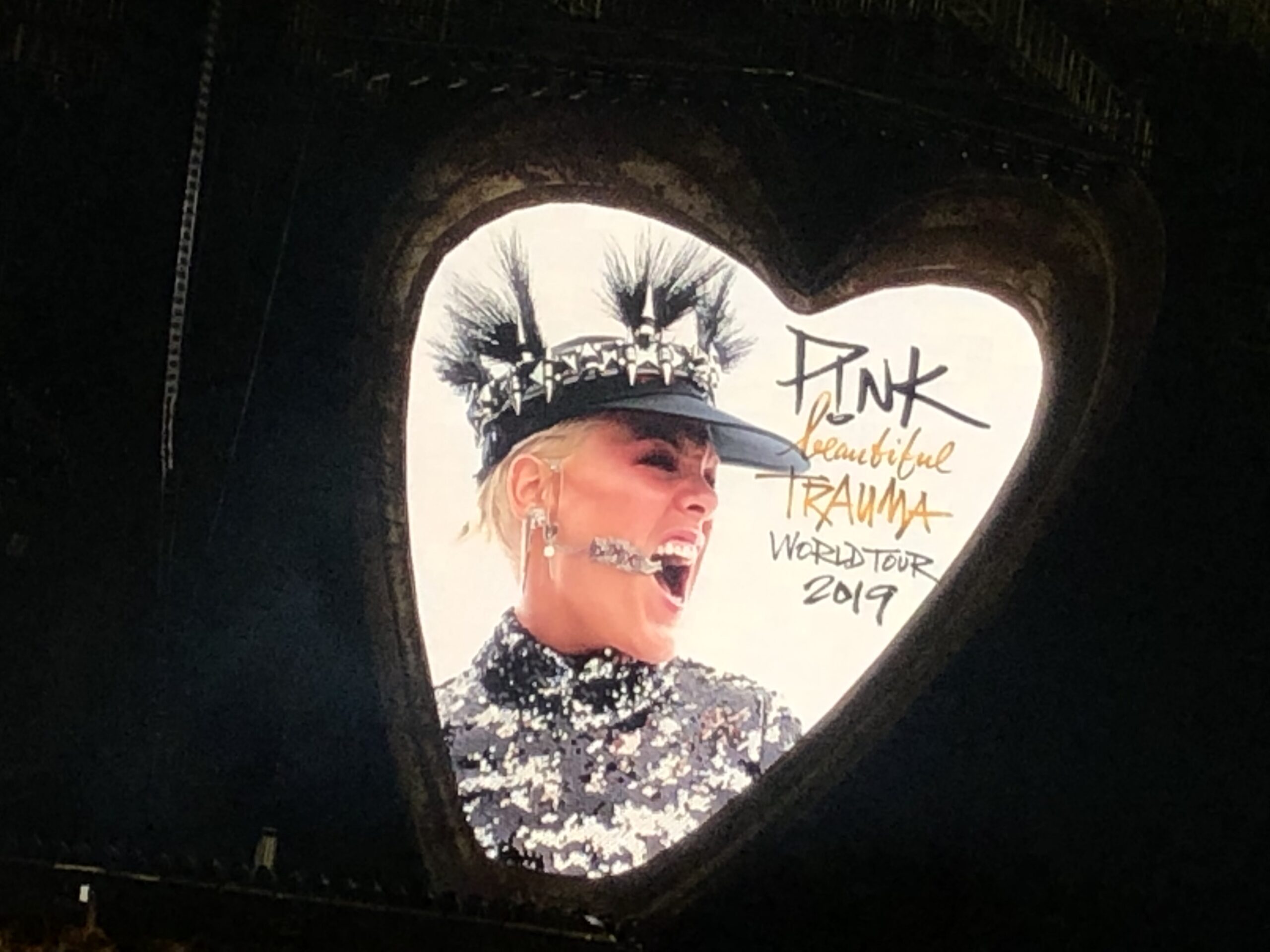 alt="heart shaped logo from Pink concert"