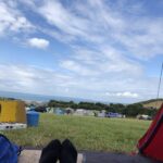 alt="tents with sea & sky"