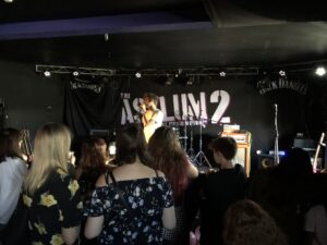 alt="person singing in front of audience"