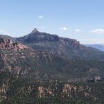 alt="mountains in distance covered in trees"