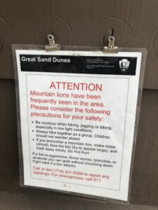 alt="clip board with warning about mountain lions"