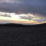 alt="sunset over sandunes"