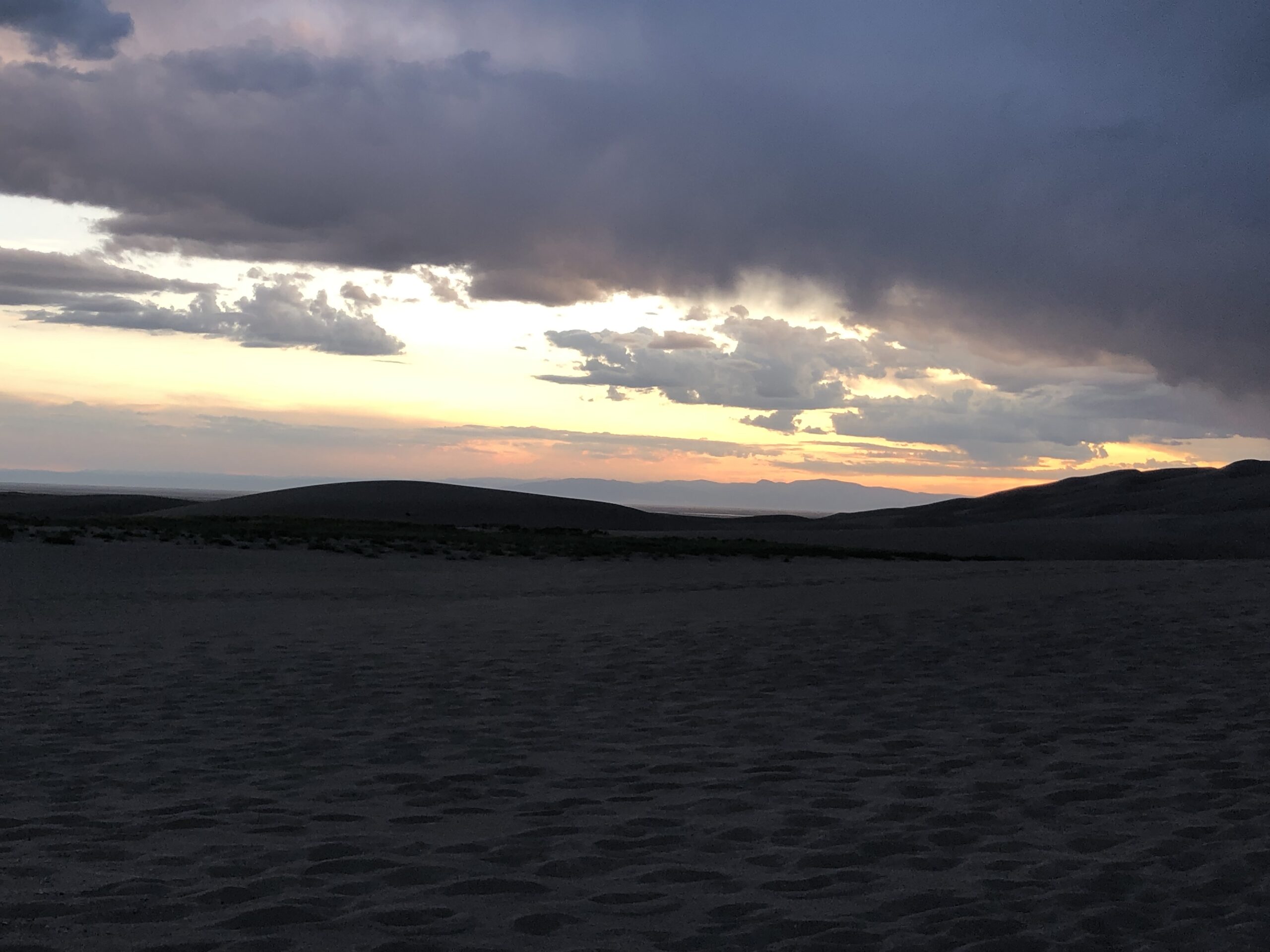 alt="sunset over sandunes"
