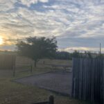 alt="empty rv site with sun going down"