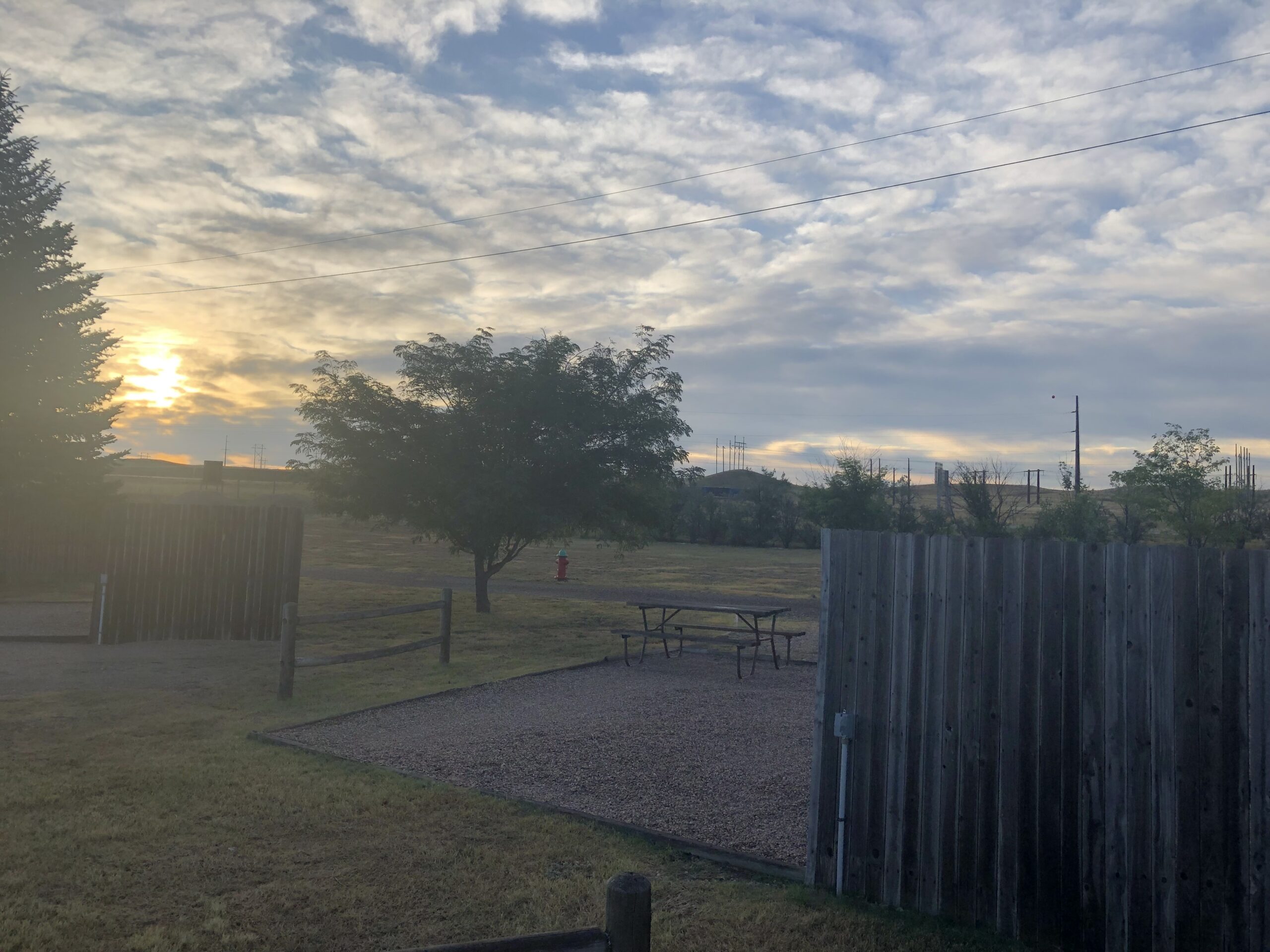 alt="empty rv site with sun going down"