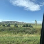 alt="grass & trees with the chimney stack tock feature in distance"