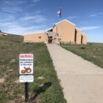 alt="building with rattlesnake warning sign"