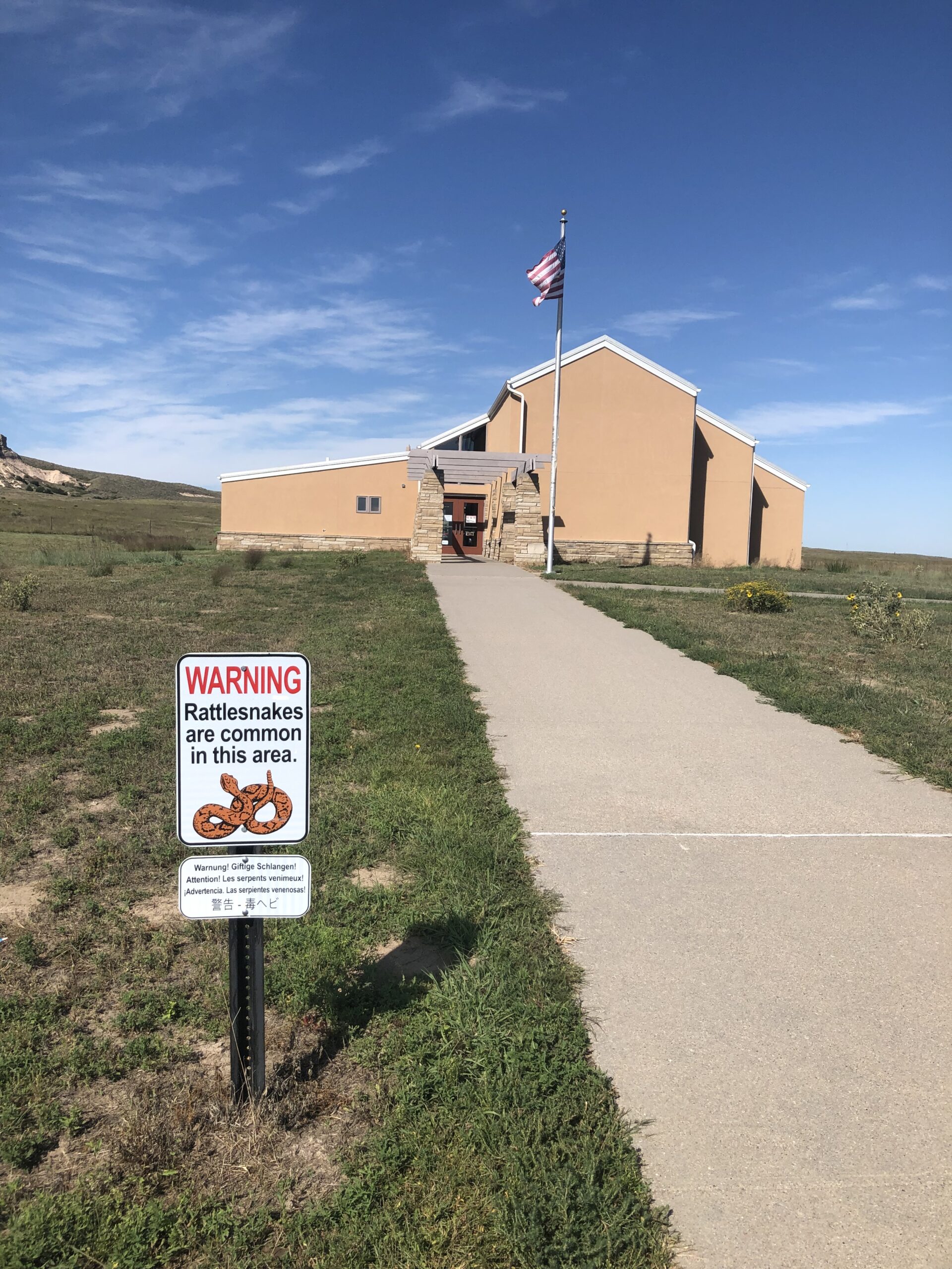 alt="building with rattlesnake warning sign"