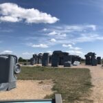 alt="cars embedded in ground"