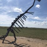 alt"dinosaur model made od old car parts"