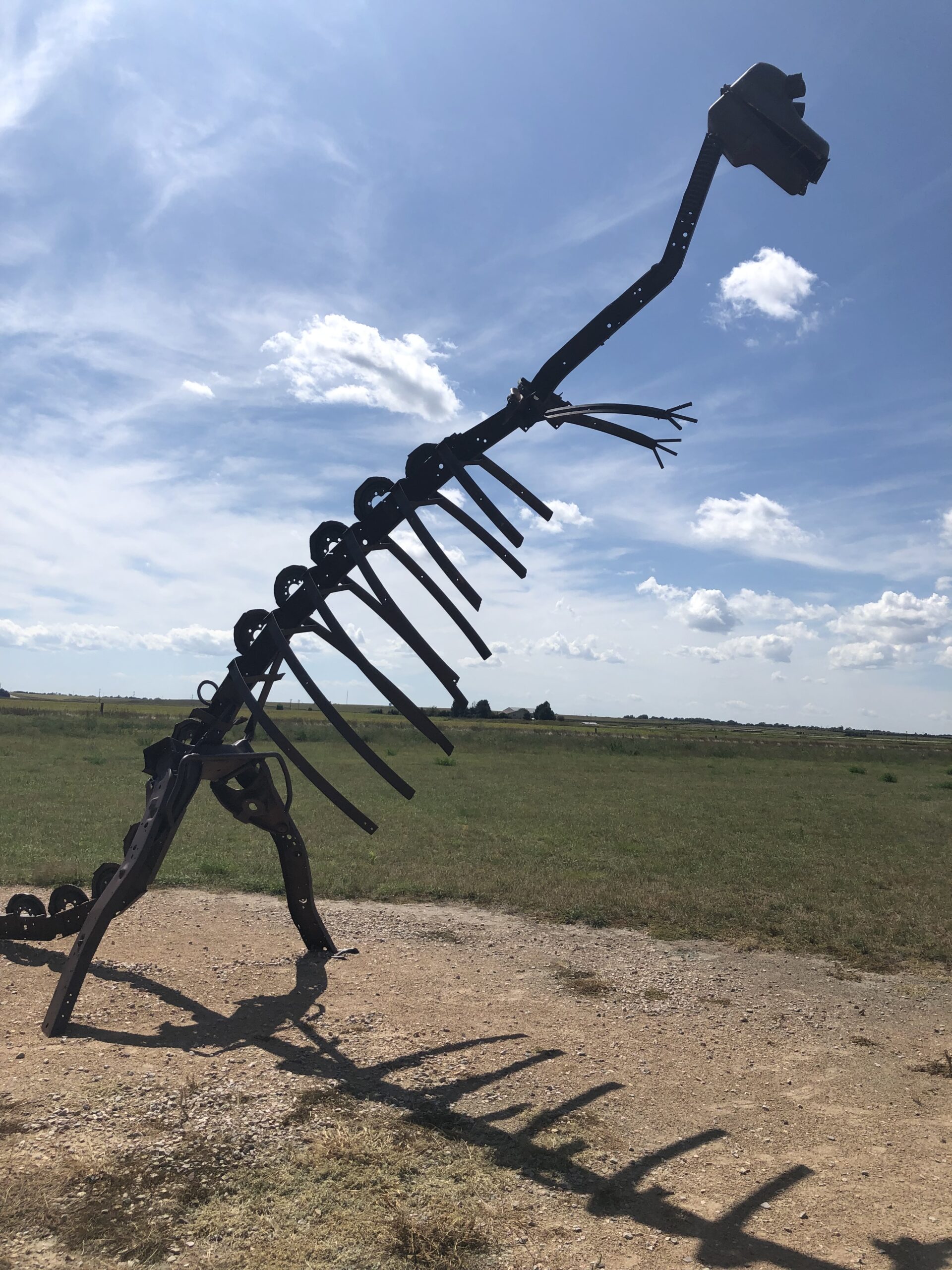 alt"dinosaur model made od old car parts"