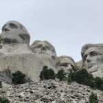 alt="scree slope with stone faces above"