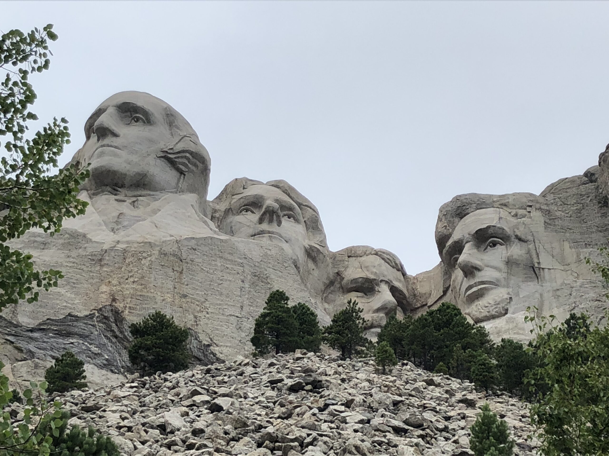 alt="scree slope with stone faces above"