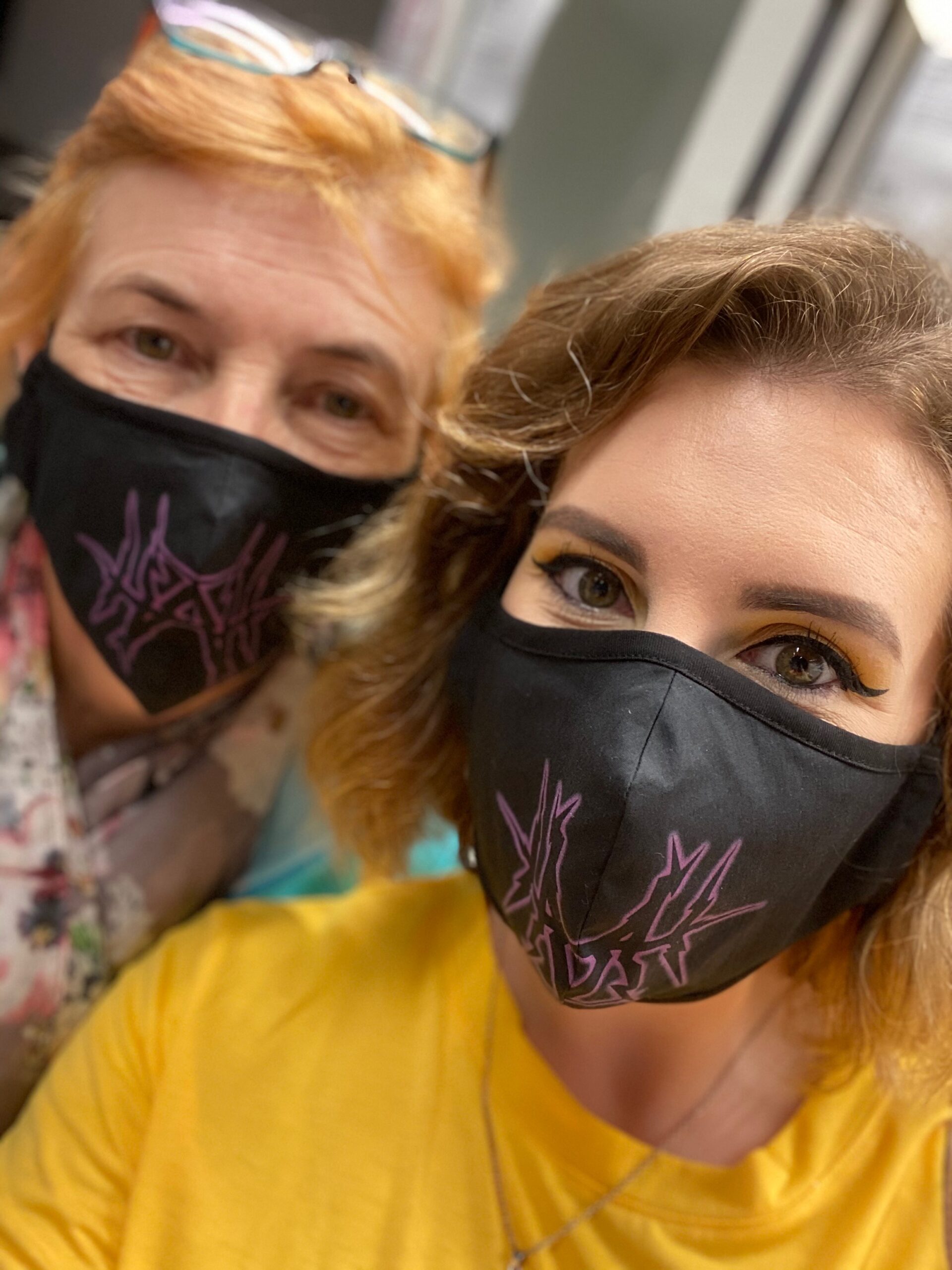 alt="two people with masks on"