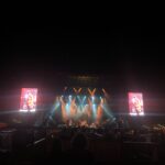 alt="main stage at night lit with coloured lights"