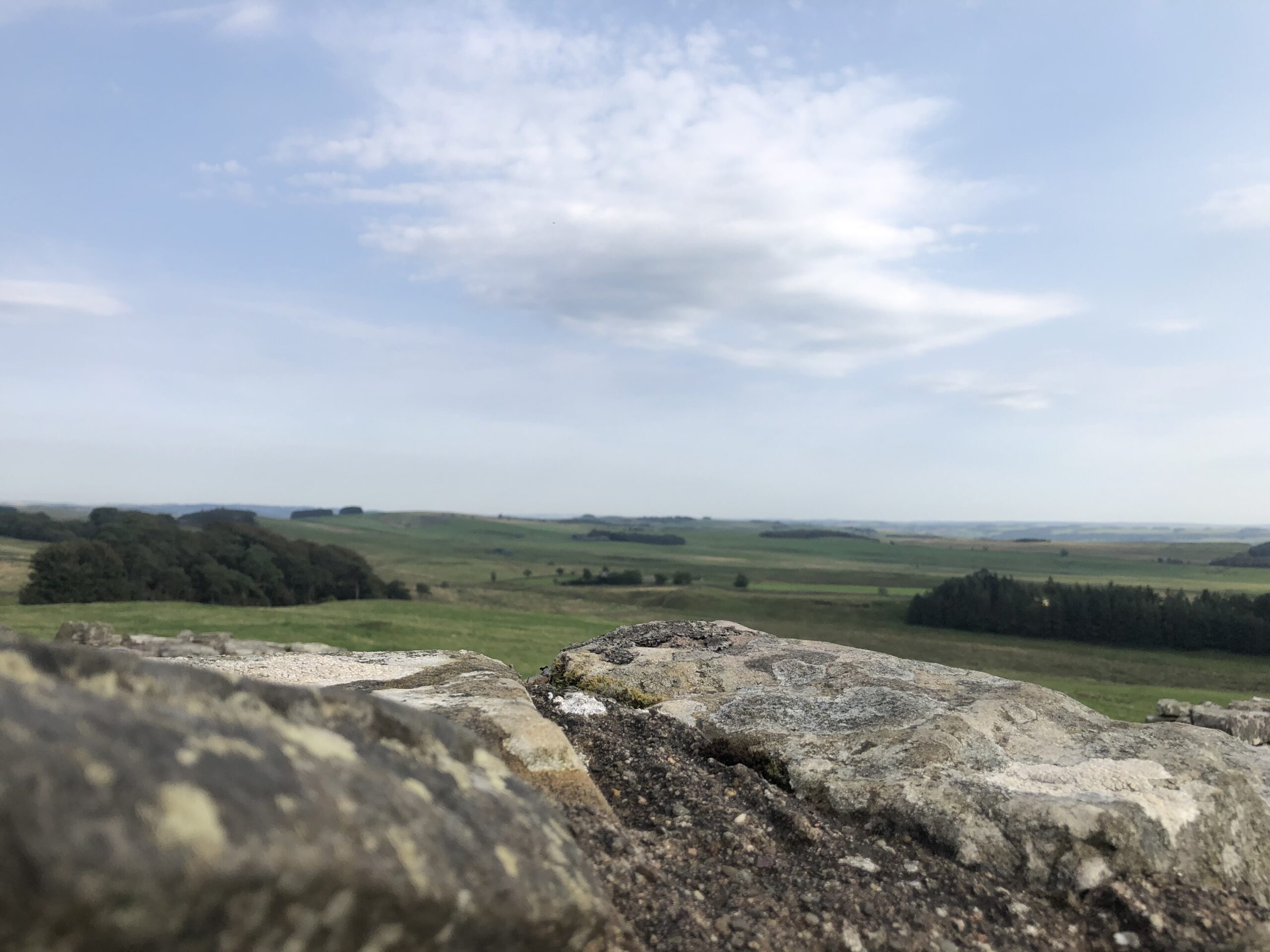alt="looking over a stone across the fields"