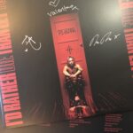 alt="album cover with person sat down"