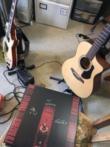 alt="guitars & a vinyl record"