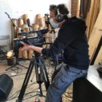 alt="person setting up camera"