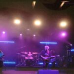 alt="guitar player in dark room"