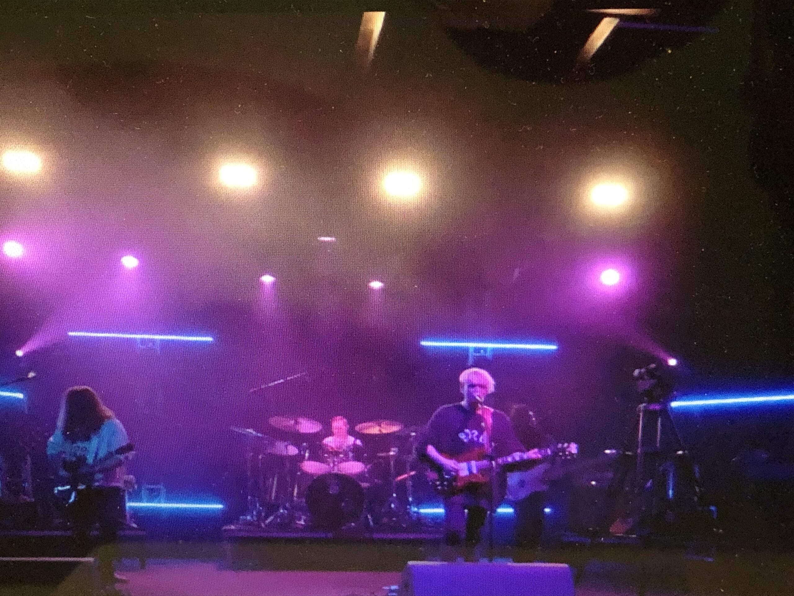 alt="guitar player in dark room"