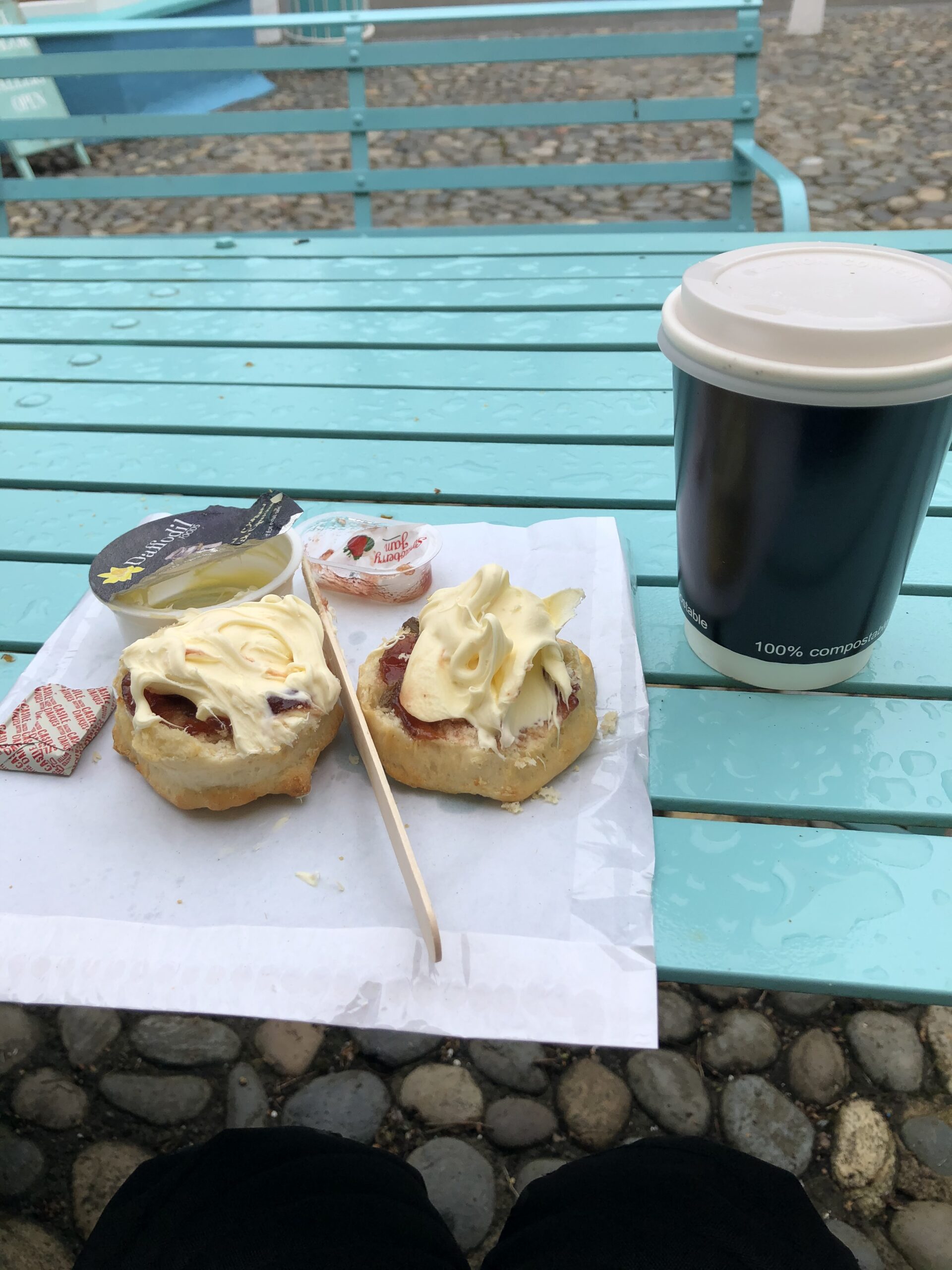 alt="cream on scones with cup of tea"