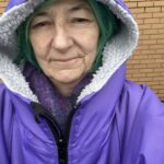 alt="person in dry robe with hood up"