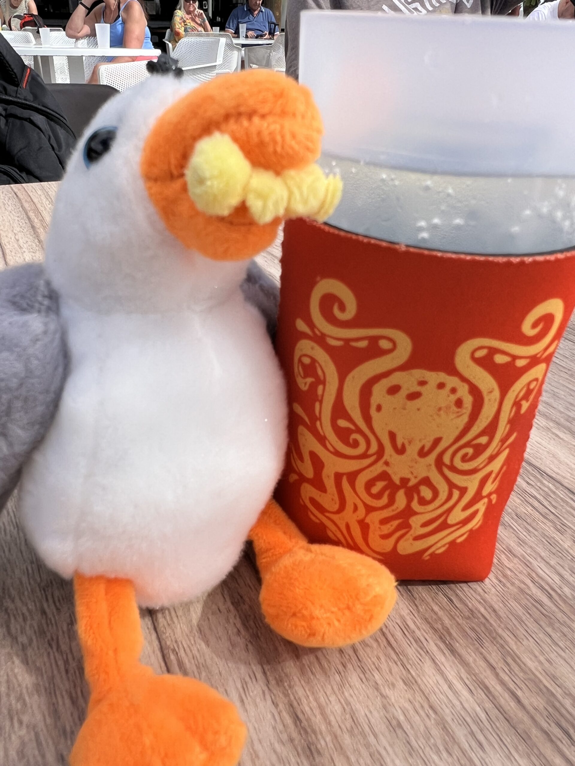 alt="toy seagull next to a glass"