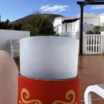 alt="plastic cup with buildings in background"