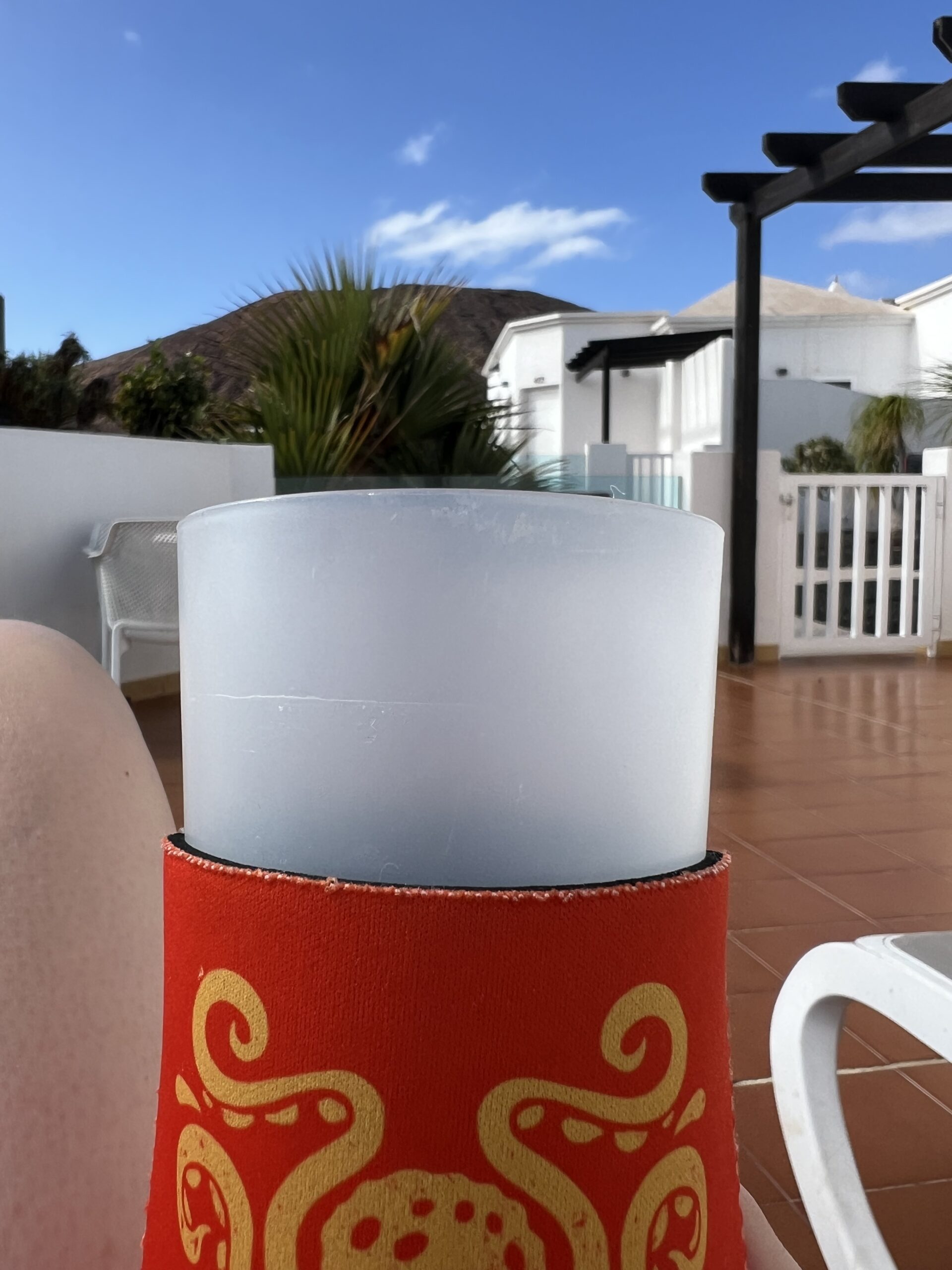 alt="plastic cup with buildings in background"