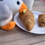 alt="toy seagull eating croissant"