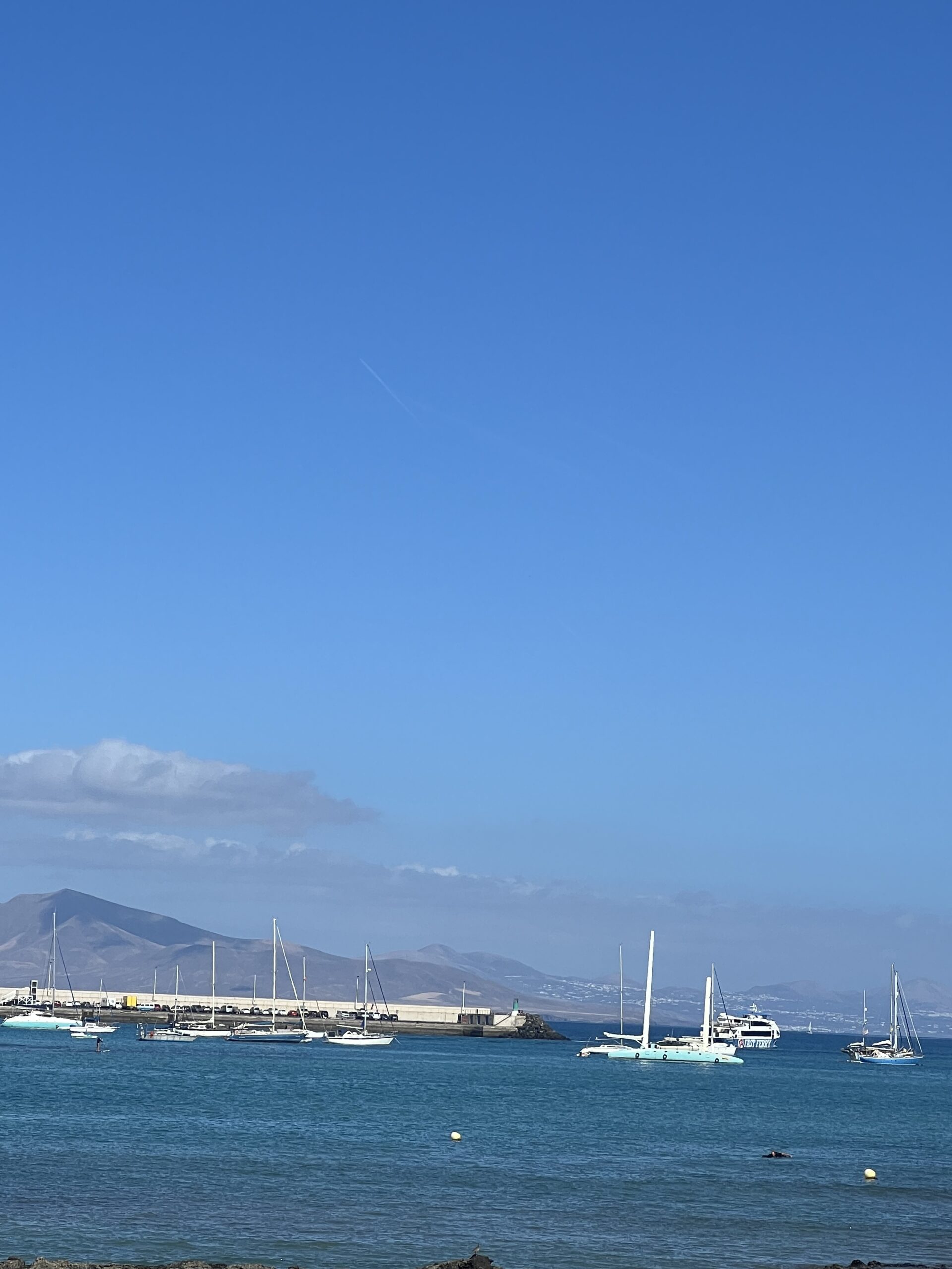 alt="small boats near harbour"
