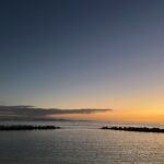 alt="calm water at sunset"