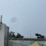 alt="children's play equipment & rainy sky"