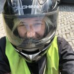 alt="person wearing motorbike helmet "