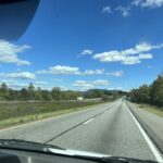 alt="road with sky & clouds"